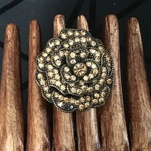 Statement flower shaped ring in bronze tone with yellow stones; flexible band